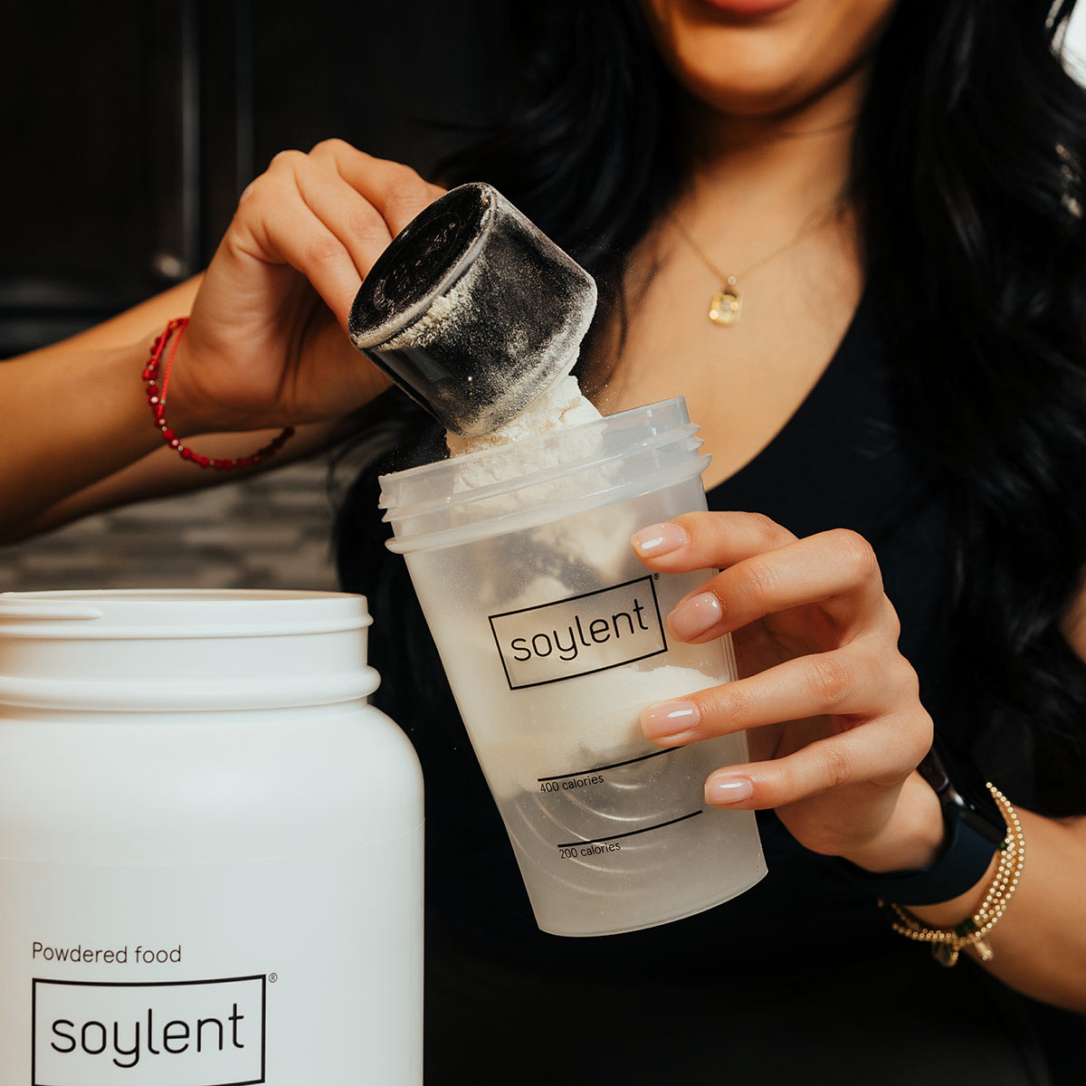 Person using Soylent Powder Scoop