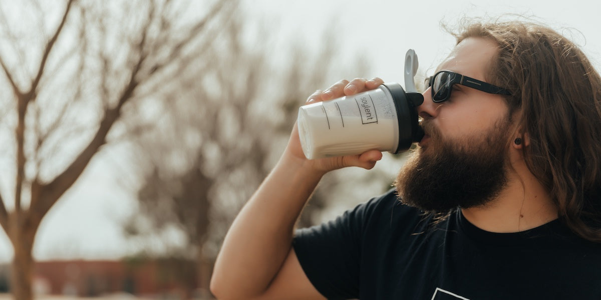 Man drinks coffee protein shake
